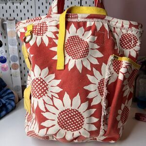 Lucky Brand canvas tote bag featuring a rust-colored fabric with off-white sunfl